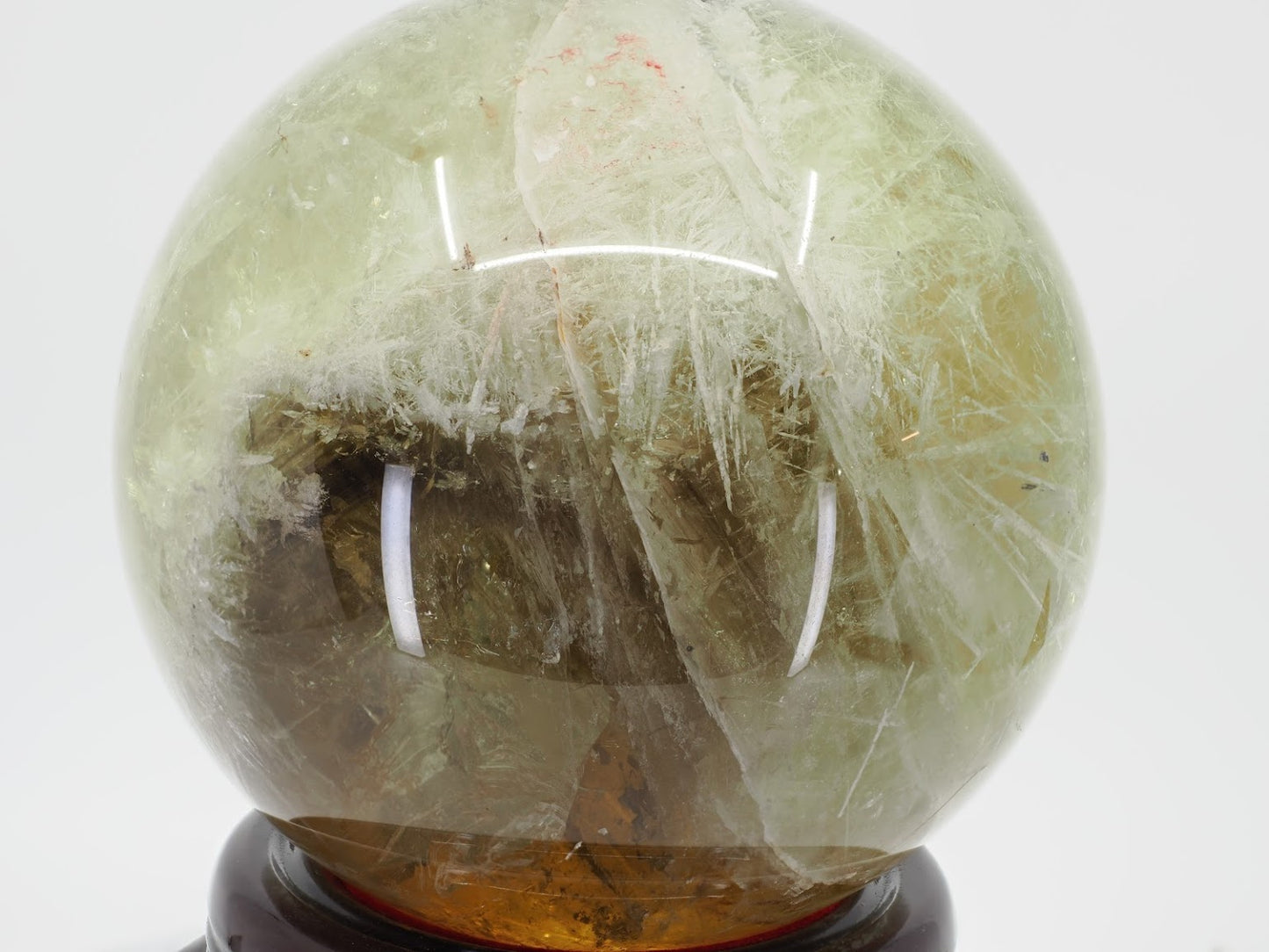 Mid-shot of 3.6kg Citrine sphere revealing depth of quartz and suspended mineral inclusions.