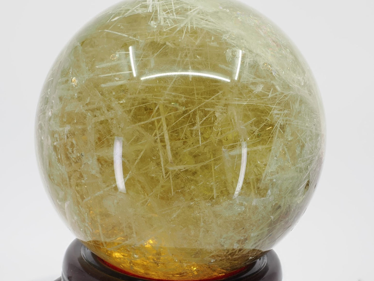 Full view of Zambian Citrine sphere filled with dense crisscrossing rutile and goethite needles.