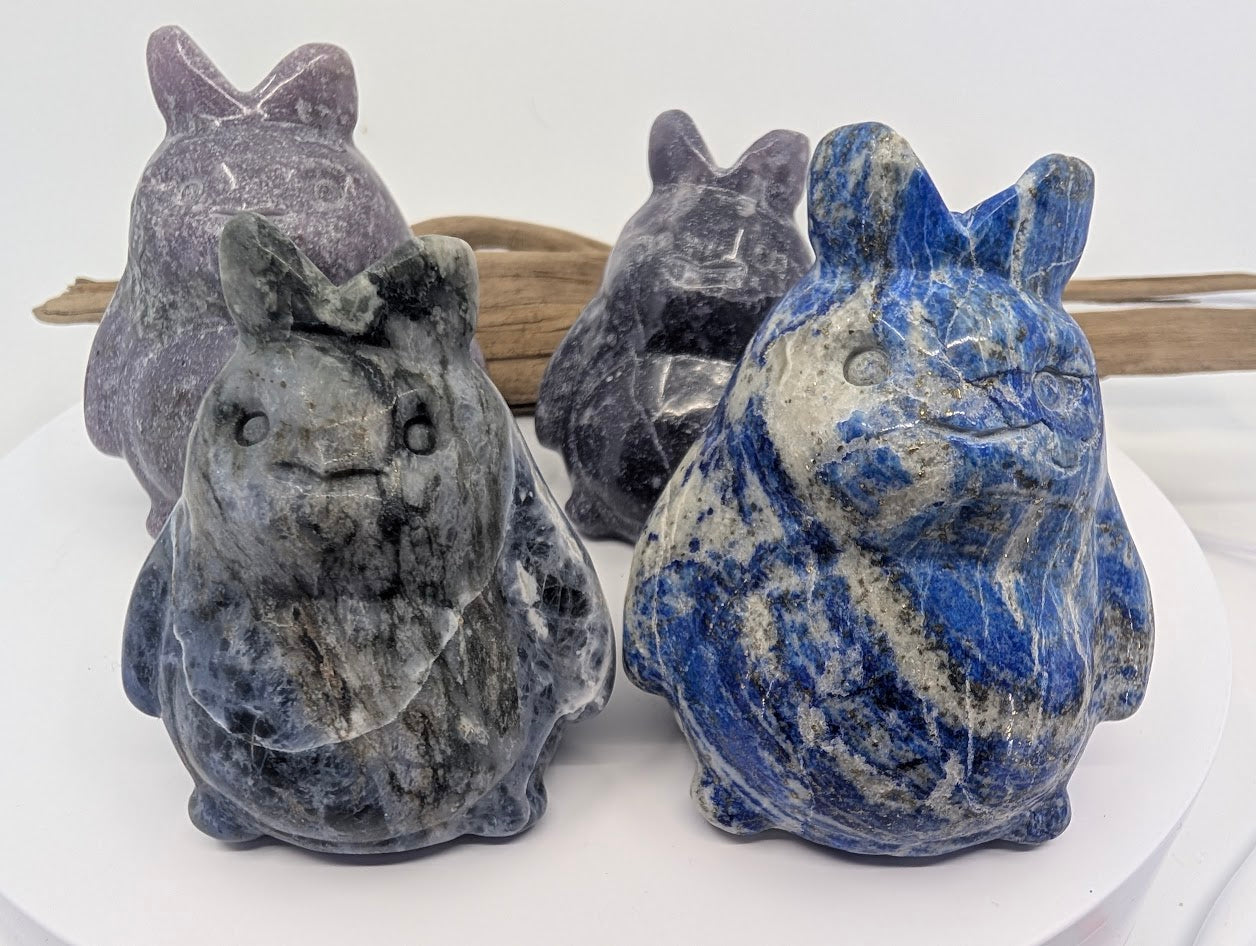 Group of four hand-carved Totoros in Lapis Lazuli, Sodalite, and Lepidolite minerals.
