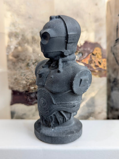 Side profile of hand-carved midnight obsidian C-3PO droid.