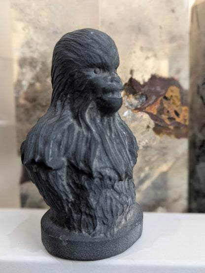 Three-quarter view of matte volcanic glass Chewbacca carving.