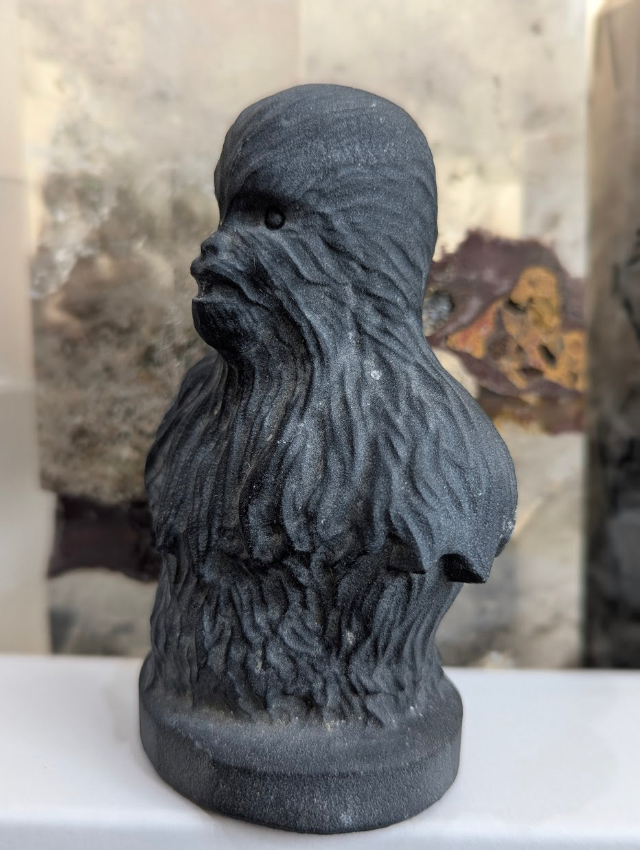 Side view of hand-carved obsidian Chewbacca showing fur texture.
