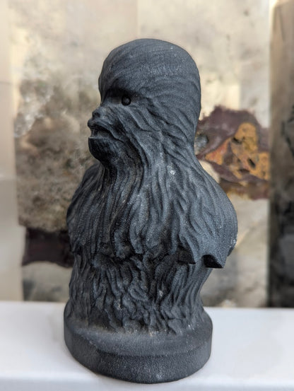 Side view of hand-carved obsidian Chewbacca showing fur texture.