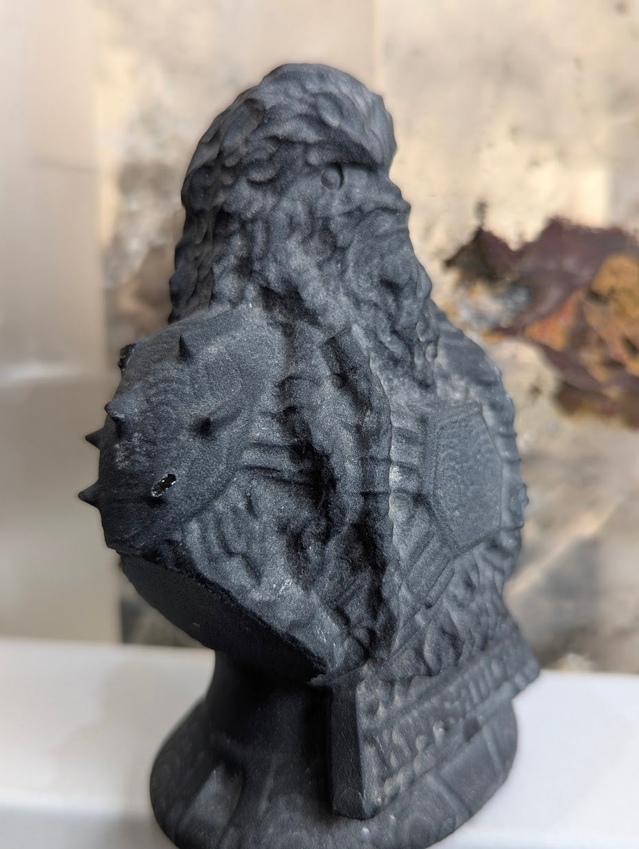 Detailed angled view of matte black obsidian Korsan carving.