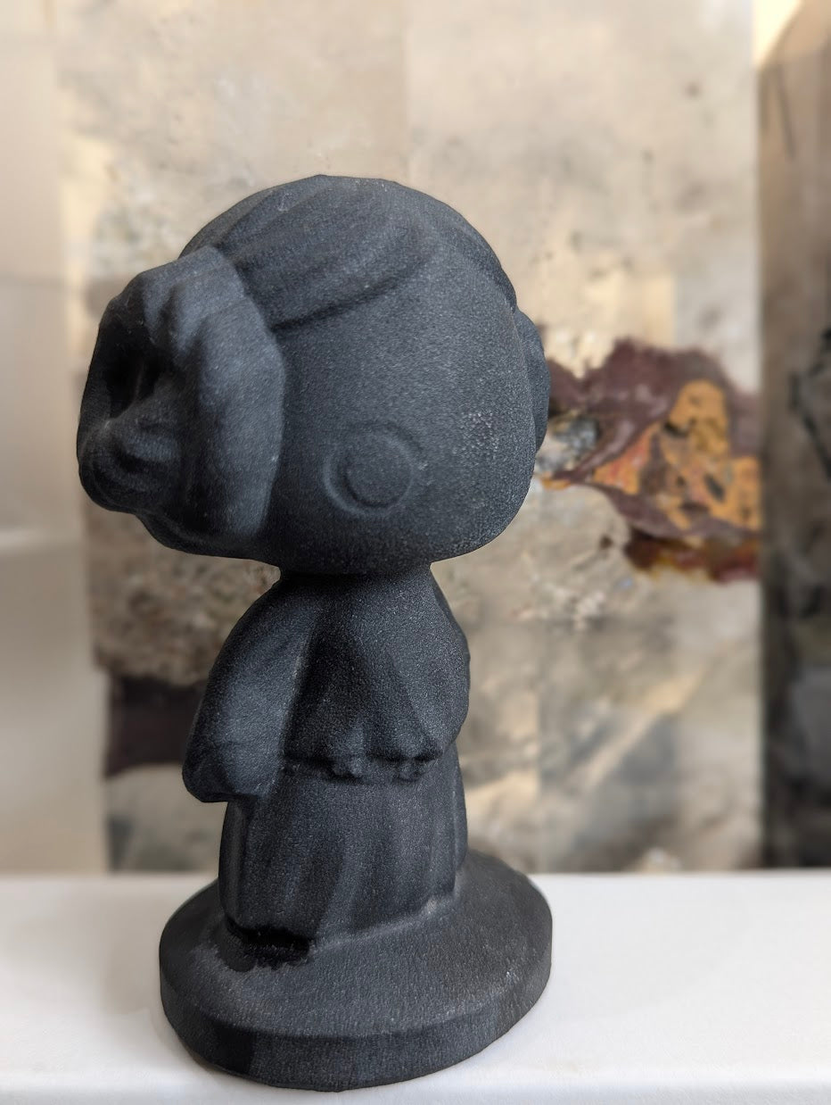 Angled view of matte black volcanic glass Princess Leia.