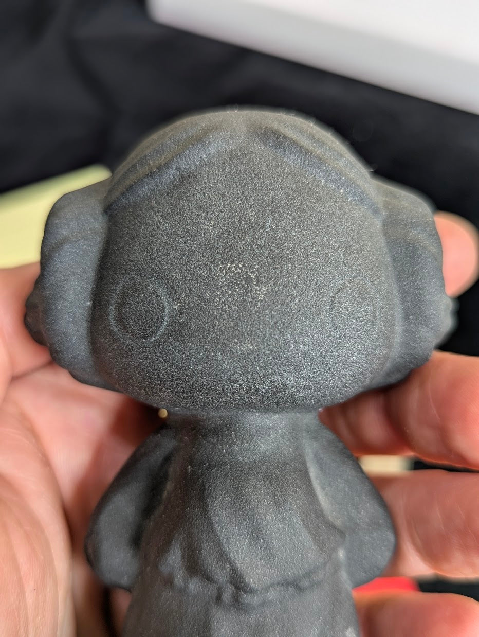 Princess Leia obsidian carving with scale reference.
