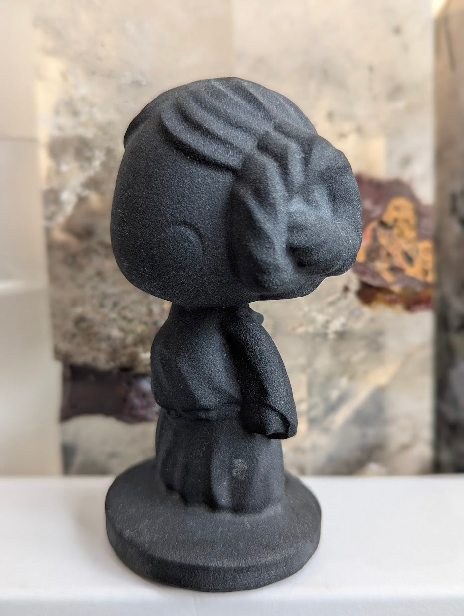 Profile view of hand-carved obsidian Princess Leia buns.