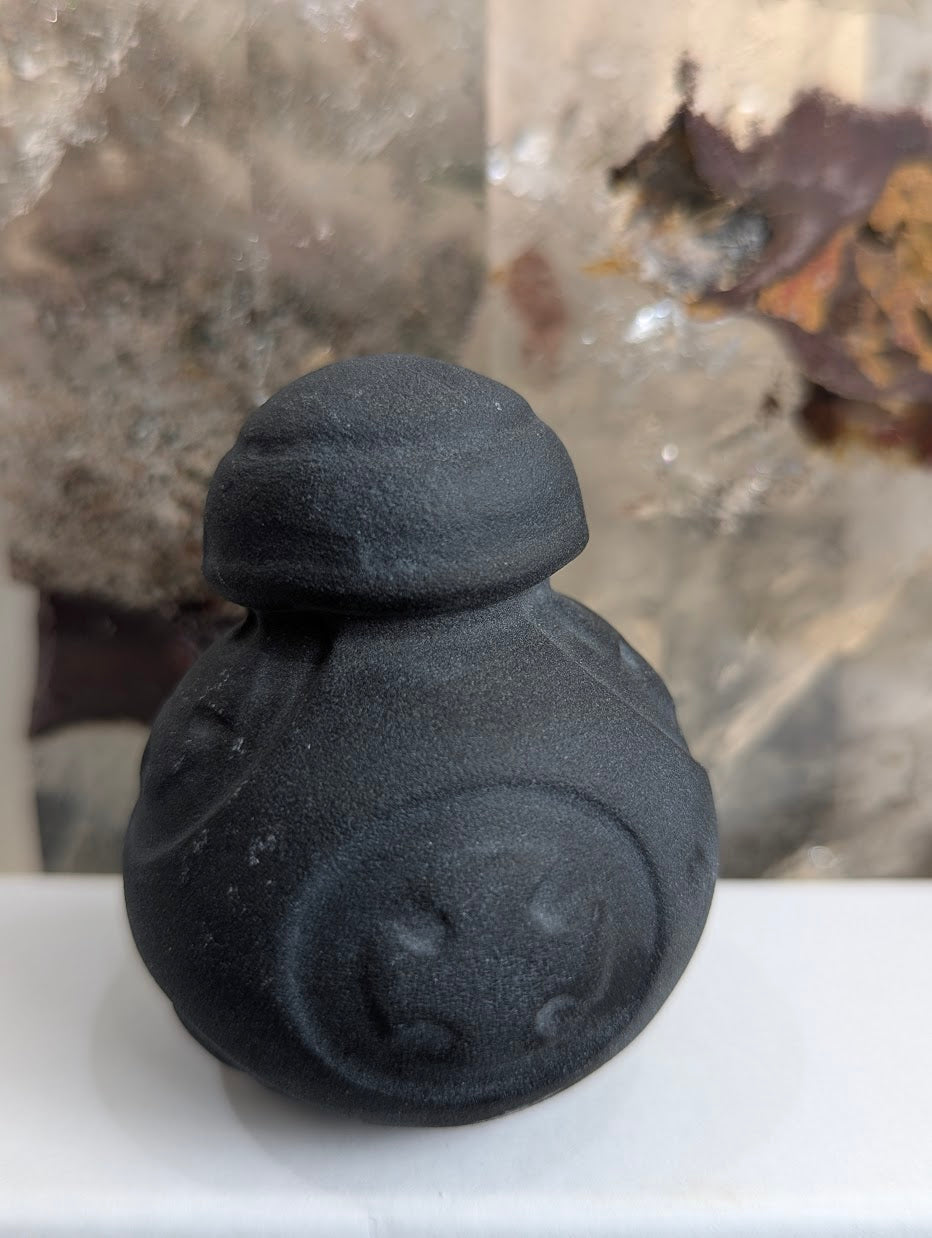 Rear view of matte black obsidian BB-8 droid carving.