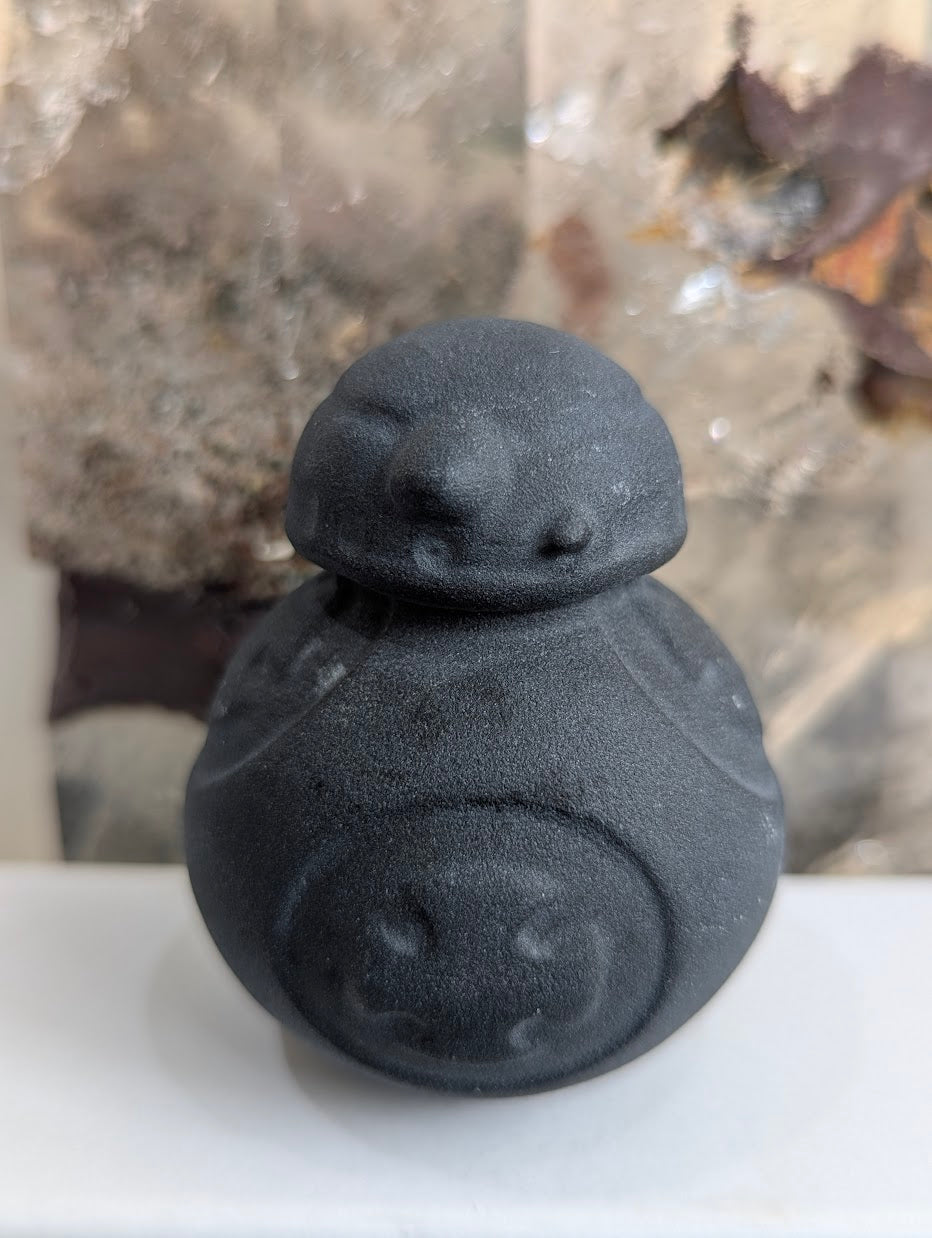 Front view of small matte black obsidian BB-8 droid.