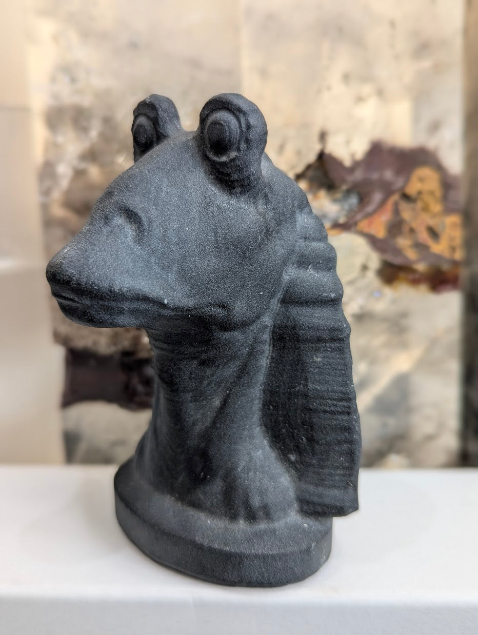 Profile view of hand-carved obsidian Jar Jar Binks showing ear detail.