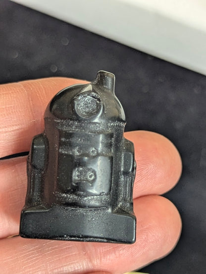Rear view of a matte black obsidian R2-D2 carving highlighting the light-absorbing matte finish and solid form.