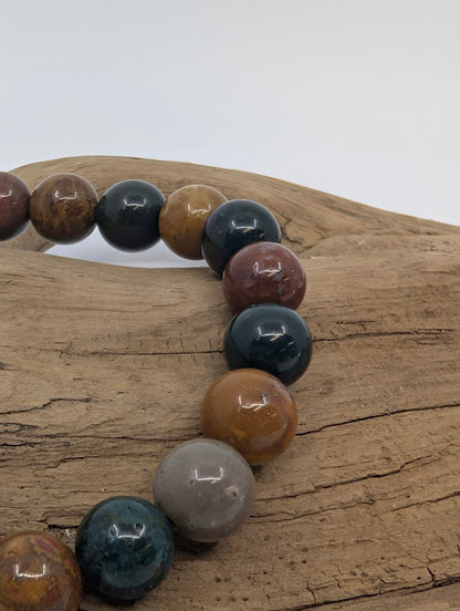 Close-up of Ocean Jasper beads showing glossy polish and orbicular patterns