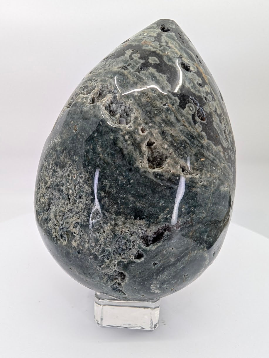 Side view of ocean jasper egg piece C with layered mineral textures