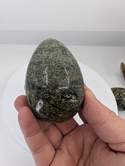 Ocean jasper egg from Madagascar, Piece A, showing orbicular patterning and natural texture in hand