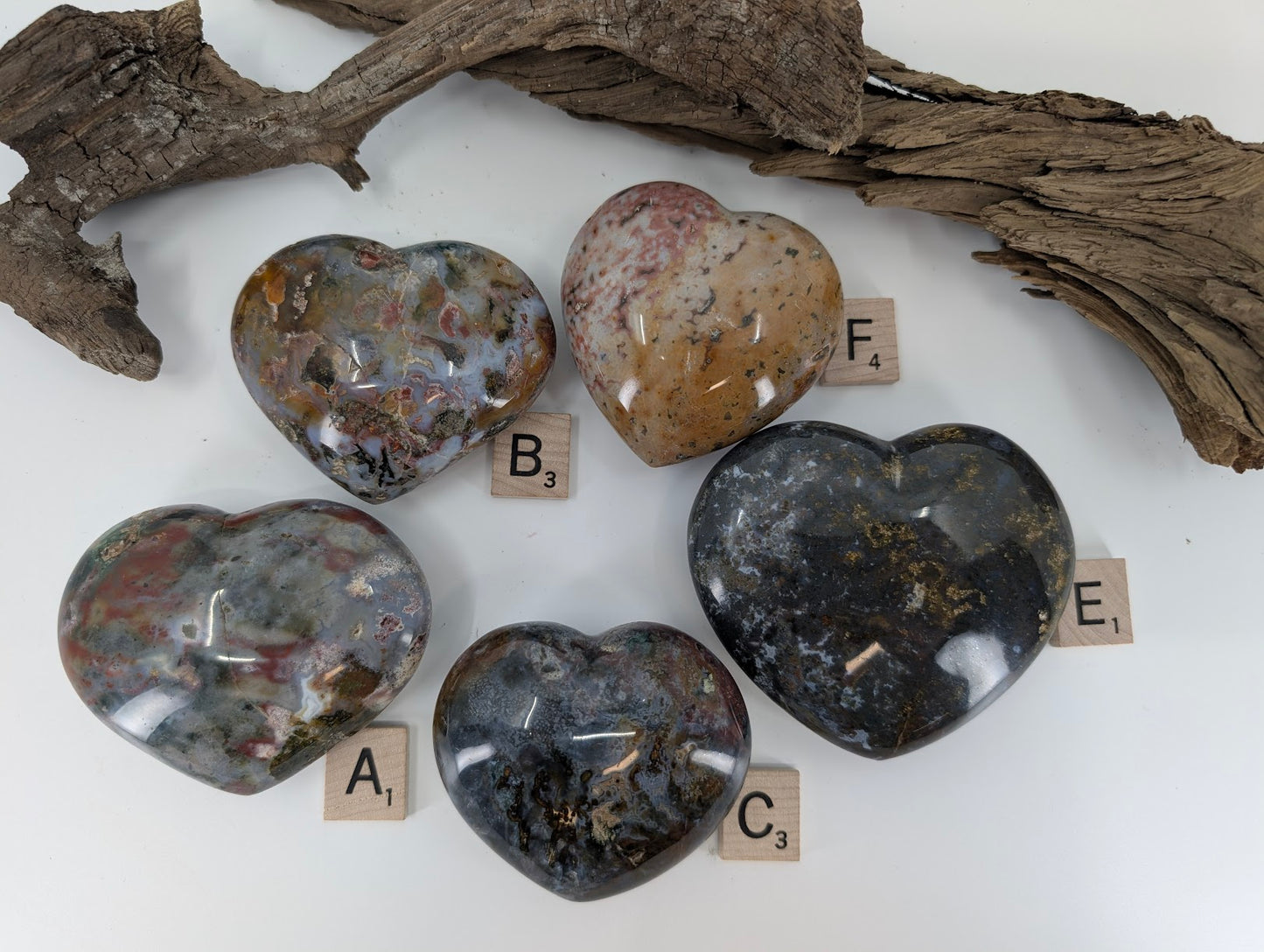 Collection of five Ocean Jasper hearts showing various orbicular patterns and colors.