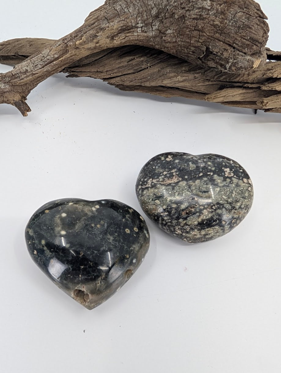Pair of dark Ocean Jasper hearts showing black matrix and grey speckles.