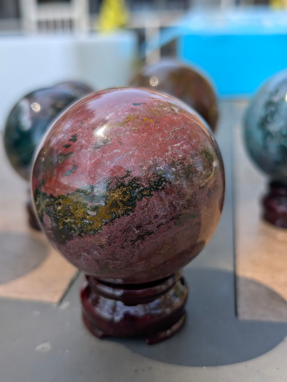 66mm Ocean Jasper sphere showcasing dramatic, sprawling orbicular chalcedony banding.