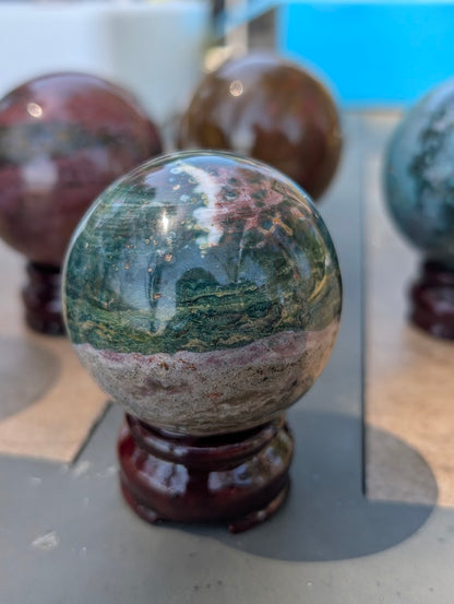 AA-grade 59mm Ocean Jasper sphere from Madagascar showing OJS-03 weight label.
