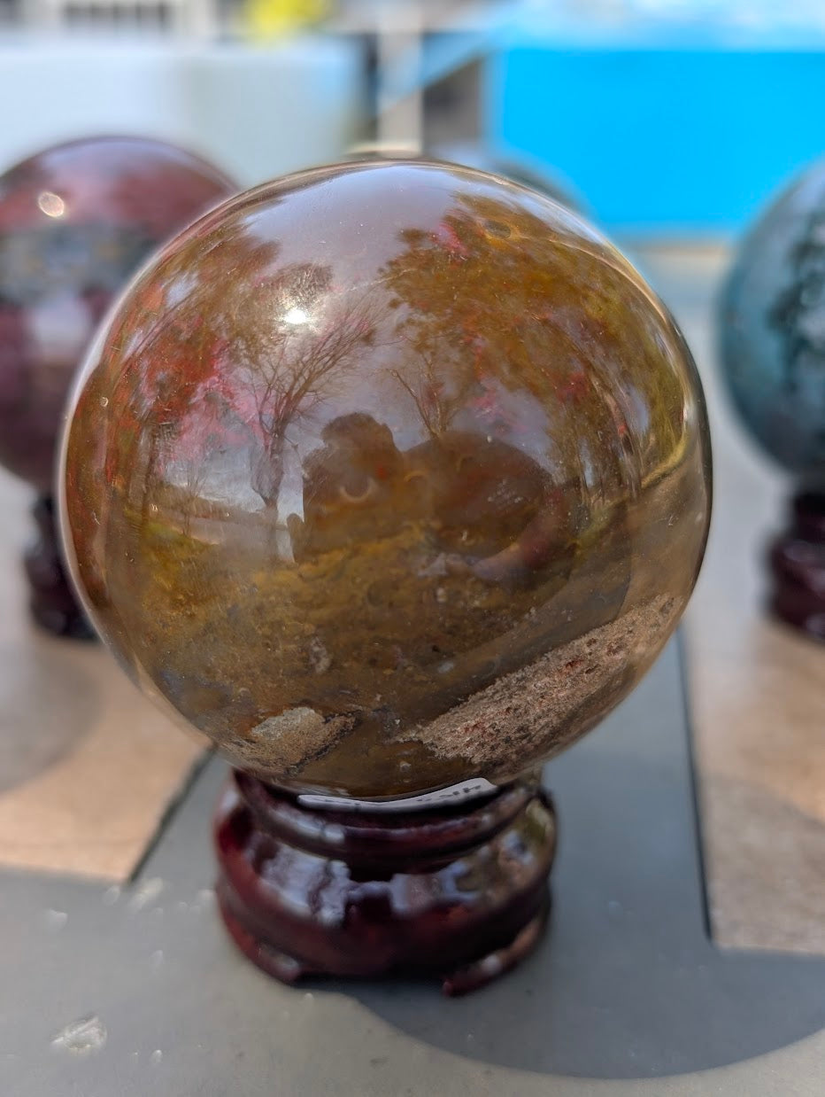 High-polish profile of 67mm Ocean Jasper sphere from Madagascar.