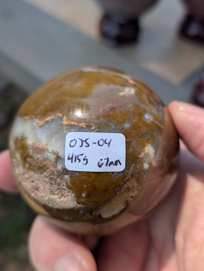 AA-grade 67mm Ocean Jasper sphere from Madagascar showing OJS-04 weight label.