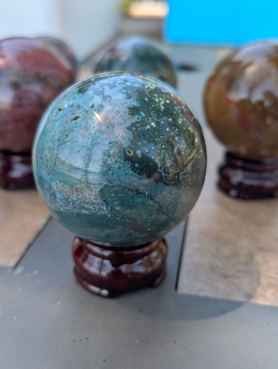 High-gloss polished surface of 66mm Ocean Jasper sphere from Madagascar.