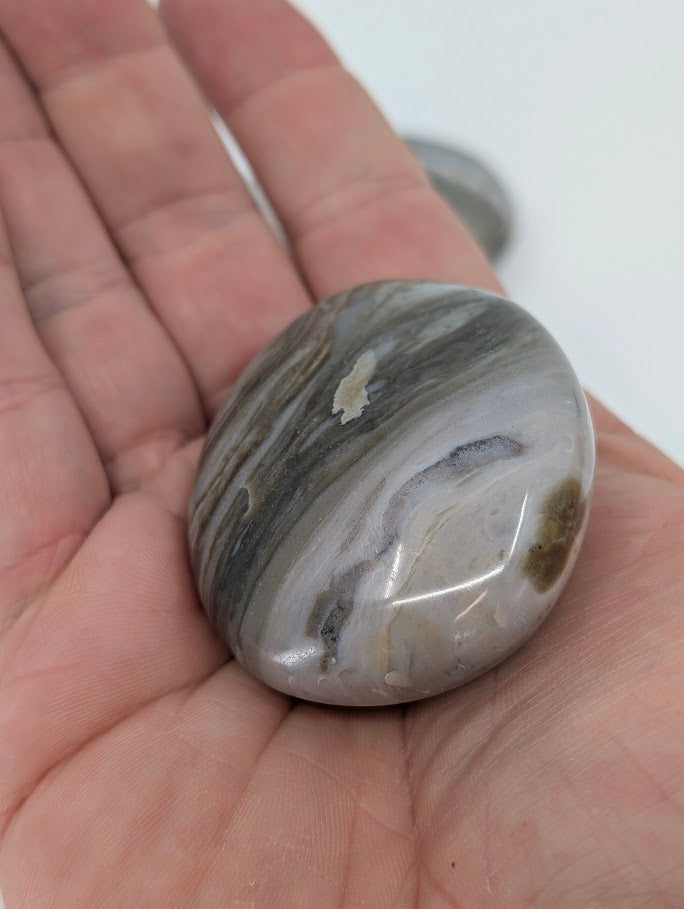 Ocean Jasper Palm Stone held in hand to show polish and band detail