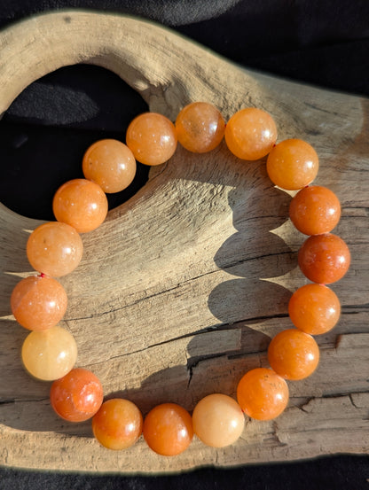 Premium 10mm Orange Aventurine beaded stretch bracelet worn on the wrist to demonstrate its 17cm (6.69") circumference scale and continuous vibrant colour profile under balanced lighting.