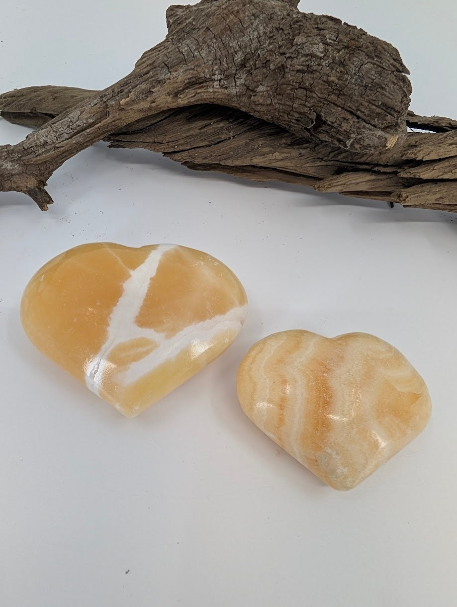 Comparison of Small and Medium Orange Calcite hearts showing vibrant citrus color.