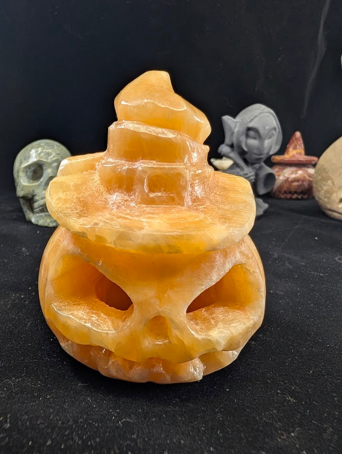 Orange Calcite Pumpkin with Witch Hat – Front View showing carved jack-o’-lantern face