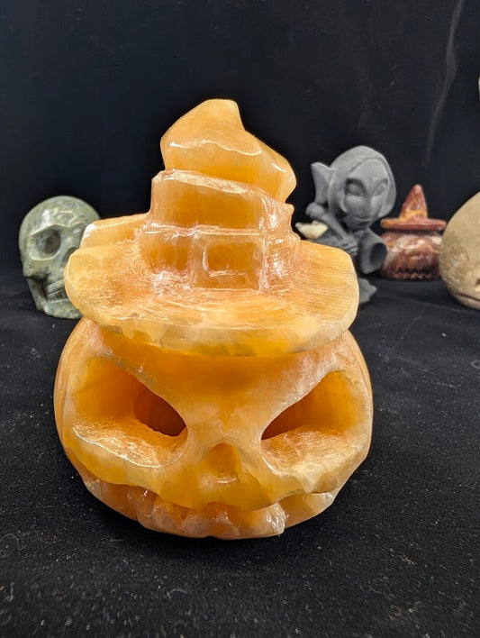 Orange Calcite Pumpkin with Witch Hat – Front View showing carved jack-o’-lantern face