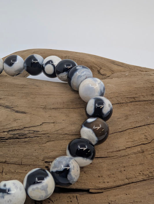 Close-up of Orca Agate beads showing high-contrast monochrome banding