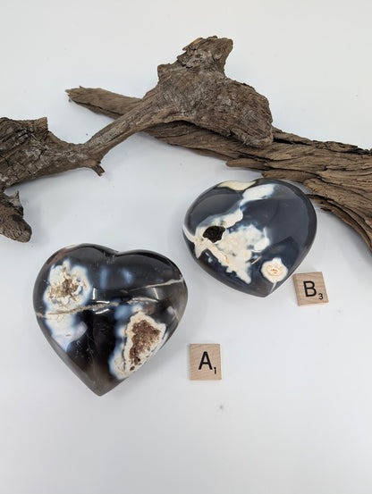 Comparison of Orca Agate hearts Specimen A (365g) and Specimen B (315g) showing white patterns.