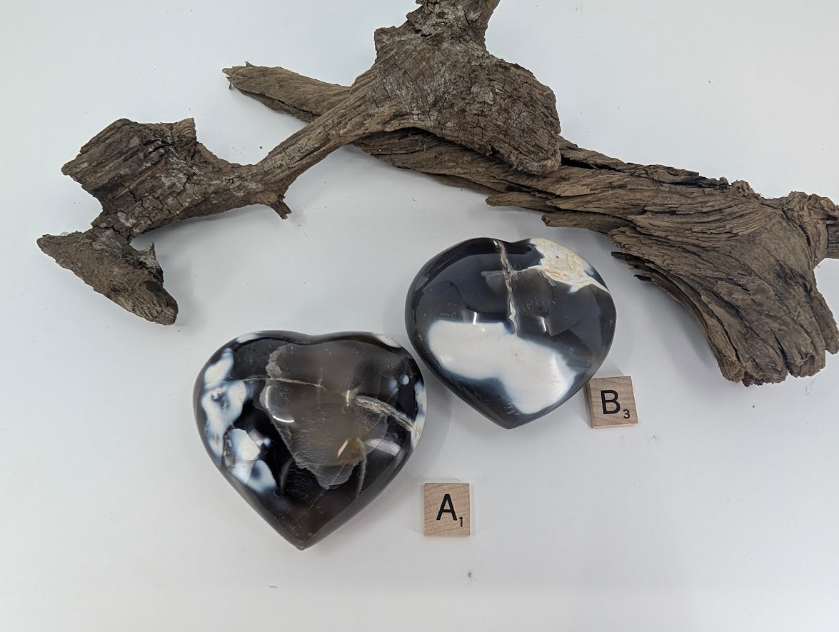 Comparison of Orca Agate hearts Specimen A (365g) and Specimen B (315g) showing white patterns.
