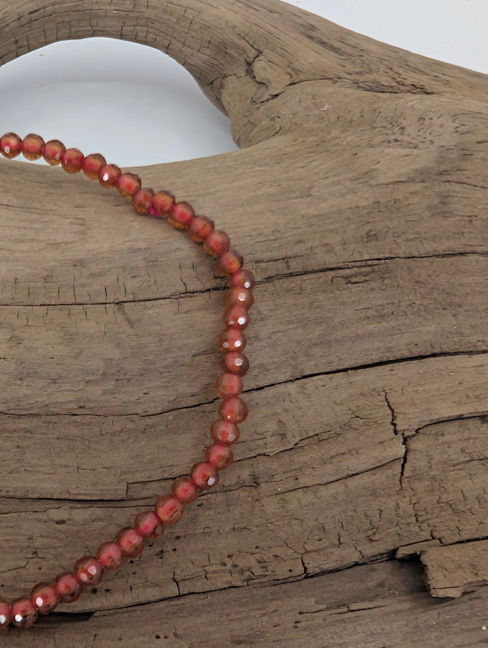 Close-up of 2.8 mm Peach Garnet bracelet showing fine facets