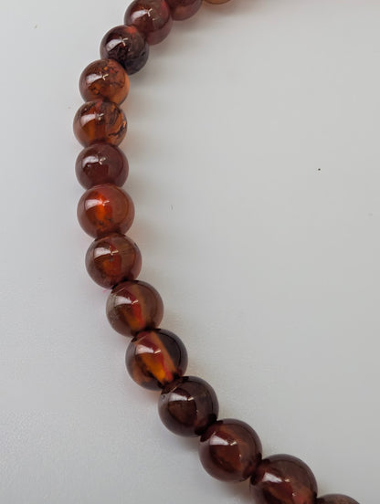 Close-up of 4mm peach garnet bracelet with well-matched round beads