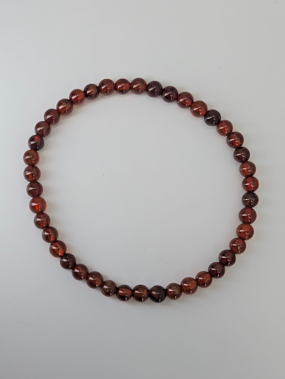 4mm peach garnet bracelet with copper-amber color and high polish