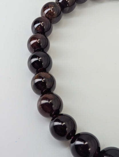 Close-up of 7mm peach garnet beads showing gemmy translucence
