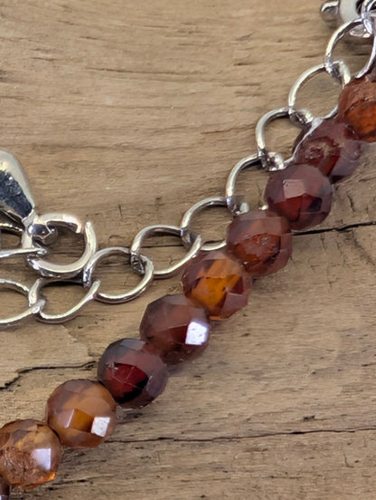 Macro view of 3mm faceted Peach Garnet beads highlighting the precision diamond-cut and natural clarity.