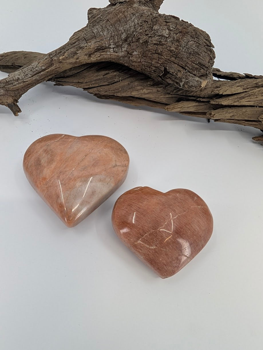 Size comparison of Small (70g) and Medium (85g) Peach Moonstone hearts.