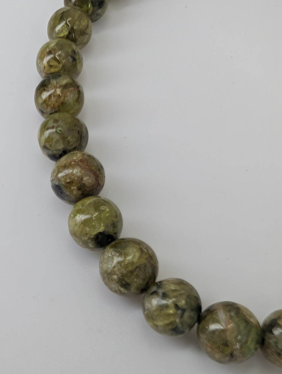 Close-up of 6 mm peridot beads highlighting natural texture and sheen