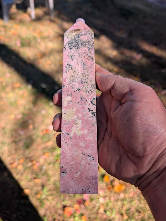 Angled view of rhodonite tower #5 with polished finish and balanced proportions