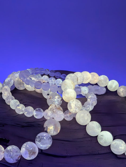 Petroleum Quartz Bracelet glowing bright yellow under UV light with vivid fluorescence