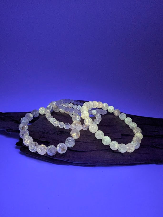 Petroleum Quartz Bracelet detail shot of glowing hydrocarbon inclusions under UV light