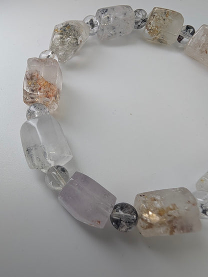 Detailed bead view showing petroleum inclusions inside quartz.