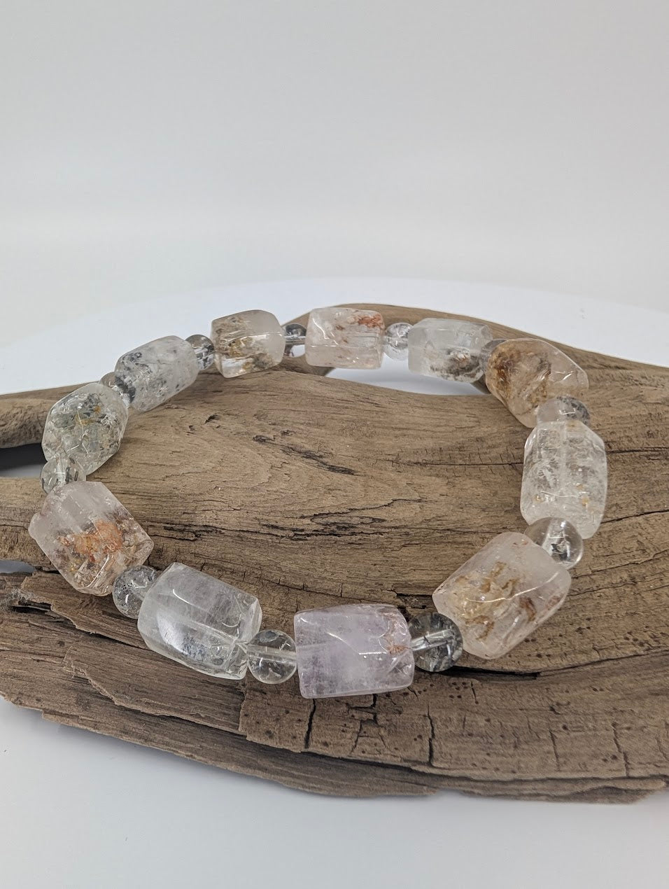 Petroleum quartz bracelet with UV-reactive hydrocarbon inclusions – close-up view.