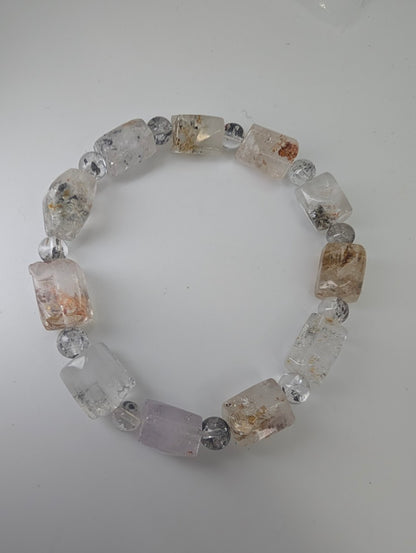 Full view of petroleum quartz bracelet with hydrocarbon inclusions.
