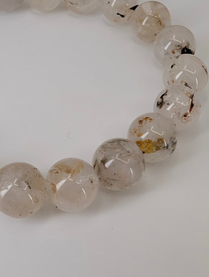 Petroleum Quartz Bracelet detail showing visible oil and carbon inclusions in clear quartz beads
