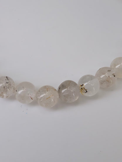 Petroleum Quartz Bracelet detail showing visible oil and carbon inclusions in clear quartz beads