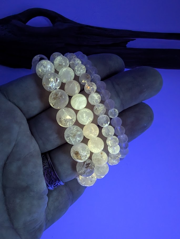 Petroleum Quartz Bracelet glowing bright yellow under UV light with vivid fluorescence