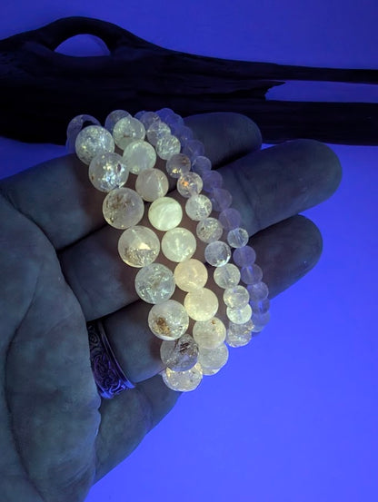 Petroleum Quartz Bracelet glowing bright yellow under UV light with vivid fluorescence